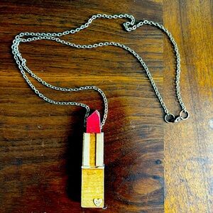 Wooden lipstick pendant on gold colored chain